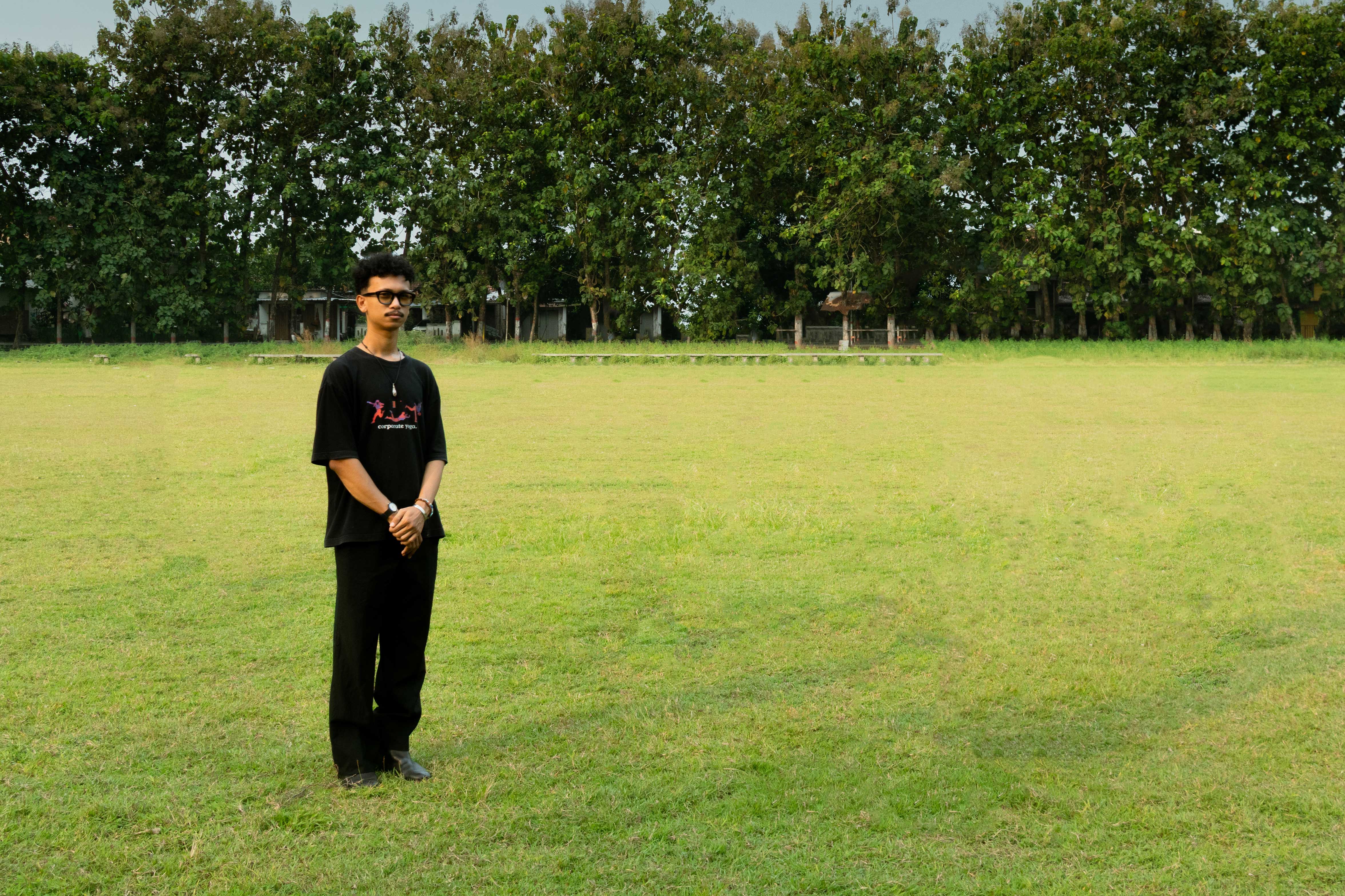 Ilham Karim standing in a green field